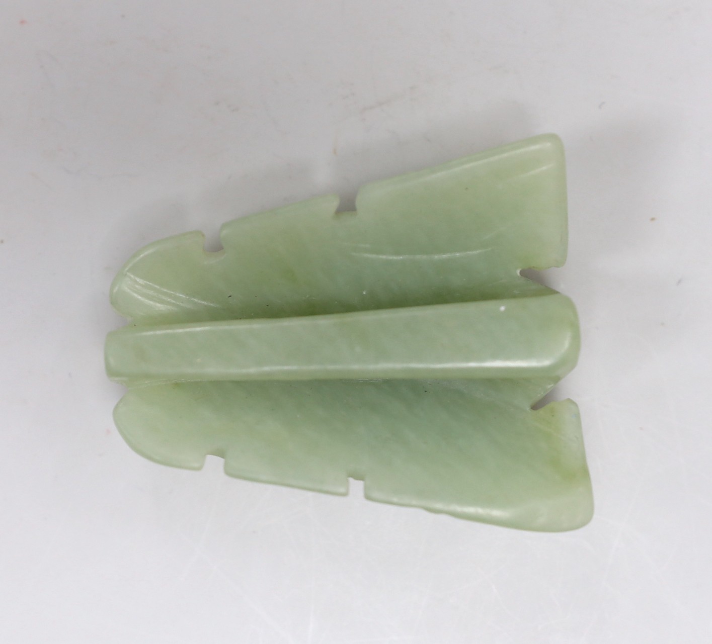 A Chinese bowenite jade dragon’s head belt buckle. 7cm wide